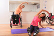 © Designpics - Young women with spinal cord injuries exercising in a yoga studio