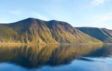 Wall Mural - Reflection of mountains on the water in the fjords in Norway