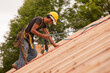© Designpics - Carpenter using safety strap on the roof of a house under construction
