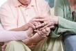 © Designpics - View of friends holding hands together.
