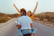 © Cavan Images - young couple travel happy by motorcycle on the road outdoors.