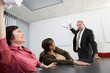© Designpics - Business people throwing papers at each other in a conference room.
