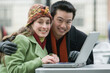 © Designpics - Portrait of a young couple with a laptop at a sidewalk cafe