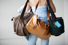 Rear View Of A Woman Carrying Bags.
