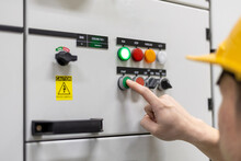 Engineer's Finger Is Pressing A Button To Test A System In Front Of A Control Panel In An Industrial Factory.