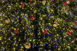 Christmas trees as new year background with many colorful christmas balls and lighting front view close up