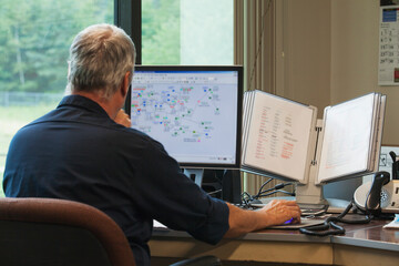 One engineer on computer starting up the water treatment plant in program for supervisory control and data acquisition