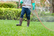 © Designpics - Pest control technician using high pressure spray gun and hose with heavy duty gloves