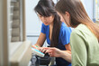 © Designpics - Two engineering students working on chemical analyzers