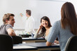 © Designpics - Students talking in an engineering class while the professor is writing on the white board