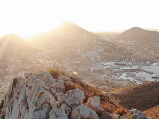 Aerial of cross in cliffs above bay in Cabo San Lucas, Mexico at sunset