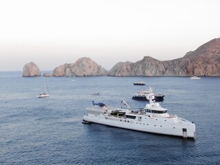 Aerial of Mega Yachts in bay of Cabo at sunset