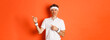 Concept of workout, sports and lifestyle. Portrait of skeptical senior sportsman in activewear, complaining about something bad, grimacing and pointing fingers right, orange background