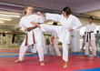 © JackF - Sporty teenager girls practicing karate in pairs during group self defence course in gym