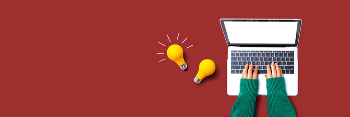 Aufkleber - Person using a laptop computer and light bulbs - Flat lay