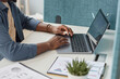 © Seventyfour - Close up of unrecognizable black man typing at laptop keyboard while using laptop at workplace, copy space