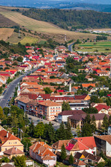 Poster - Aerial view of the town center with hills, buildings, streets, vegetation and surroundings in Rupea, Romania, 2021