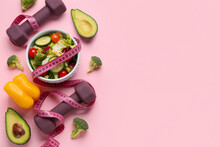 Bowl With Vegetable Salad, Dumbbells And Measuring Tape On Color Background