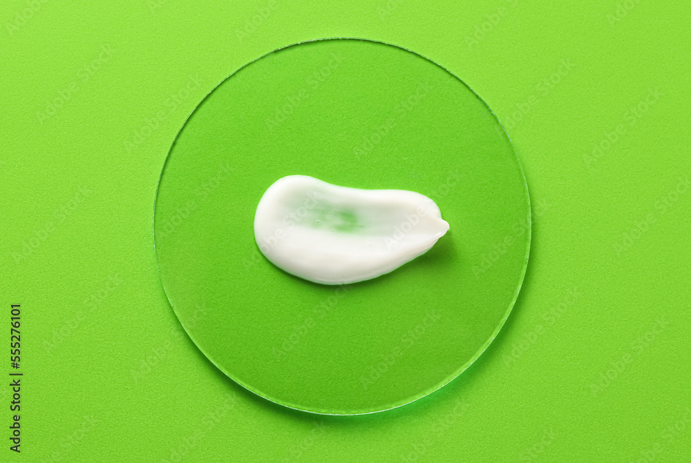 Sample of moisturizing cream on green background
