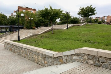 Wall Mural - view of park with steps, lamps and green grass