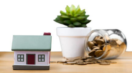 Canvas Print - House model and coins in glass bottle