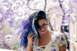 © Austockphoto - young woman posing under jacaranda tree