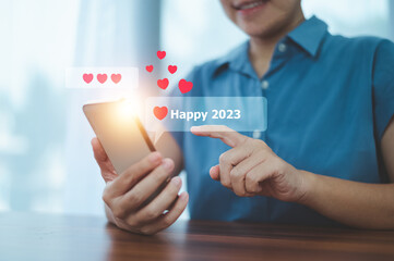 People using mobile smartphone sent message happy 2023 for happy new year concept