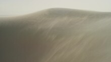 Wide Panning Shot On Windy White Sand Dunes On Stormy Day