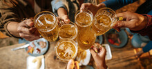Portrait Of Happy Asian Friends Having Dinner Party Together - Young People Toasting Beer Glasses Dinner Outdoor  - People, Food, Drink Lifestyle, New Year Celebration Concept.