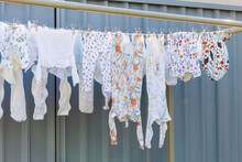 Baby Clothes, Cloth Nappy Inserts Hanging On Washing Line With Environmentally Friendly Metal Pegs