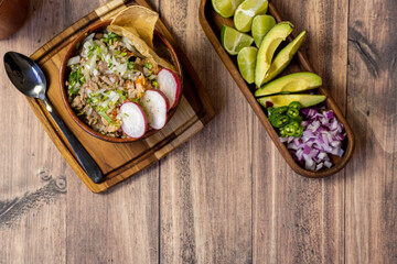 tostadas carne typical mexican food, wooden plate and wooden bottom, radish and onion