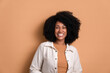 Leinwanddruck Bild - happy black young woman smiling and standing wearing white jacket in beige background. portrait, real people concept.