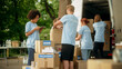 © Gorodenkoff - Group of Hardworking Volunteers Preparing Donated Free Food Rations, Loading Packages in a Cargo Van on a Sunny Day. Charity Workers Work in Local Humanitarian Aid Organization.