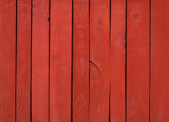 Wall Mural - Close up of red painted wooden fence panels.