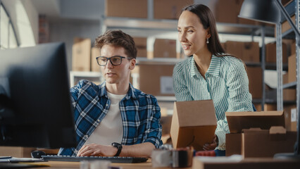 Wall Mural - Warehouse Inventory Manager and Worker Using Desktop Computer, Preparing a Parcel for Shipping. Small Business Owners Working in Storeroom, Preparing Online Orders for Clients. Slow Motion