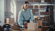 © Gorodenkoff - Beautiful Storeroom Worker Preparing a Small Parcel for Postage. Inventory Manager Taping a Cardboard Box Before Shipping It to Customer. Small Business Owner Working in Warehouse Facility.