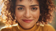 © Gorodenkoff - Close Up Portrait of a Young Middle Eastern Woman with Short Curly Hair, Looking for Camera, Wearing a Yellow Sweater. Beautiful Diverse Multiethnic Female Wearing Yellow Smiling and Being Happy.