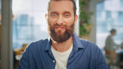 Poster - Portrait of a Handsome Man in Creative Agency. Young Stylish Manager with Long Hair and a Beard Looking at Camera. Successful Manager Working in Modern Company.