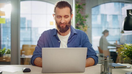 Poster - Portrait of a Handsome Man in Creative Agency. Young Stylish Manager with Long Hair and a Beard Looking at Camera. Successful Manager Working in Modern Company.