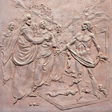 Fototapeta  - VARENNA, ITALY - JULY 20, 2022: The modern bronze relief Resurrection of Lazarus on the gate of church Chiesa di Santa Marta by Giuseppe Abramini from 20. cent.
