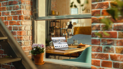 Poster - Laptop Computer with Online Shopping Website Display Standing on a Table in Stylish Living Room. View from Outside the Window of a Brooklyn-Style Brownstone Building. Work from Home Concept.