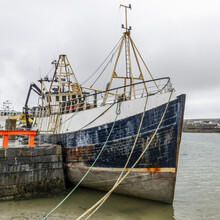 Ship Moored In The Harbour Along The West Coast Of Ireland At The Mouth Of The Galway Bay, Inishmore, Aran Islands; Kilronan, County Galway, Ireland