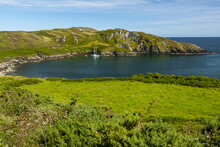 Sailboat Moored In A Tranquil Bay Along The Coast Of Ireland; Ireland