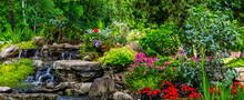 Landscaped Flower Garden In Bloom With Water Feature In A Yard; Hudson, Quebec, Canada