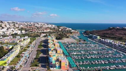 Wall Mural - Aerial view of sea bay of marina for ships and yachts with a perspective on picturesque tourist town of Albufeira. Portugal, Algarve. with sea views.