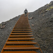 © Designpics - Climbing metal steps up volcanic rock in the rain; Snaefellsbaer, Western Region, Iceland