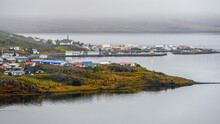Town Along The Coast With Low Cloud Over Tranquil Water And Houses; Strandabyggo, Westfjords, Iceland