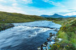 © Designpics - Small rapids on a river flowing through Connemara with a mountain in the background on a blue sky day; Connemara, County Galway, Ireland