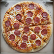 © Designpics - Overhead View of Whole Pepperoni and Cheese Pizza in Cardboard Box