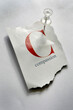 © Designpics - Close-up of Torn Page with C and Compassion on it, Pinned to Board